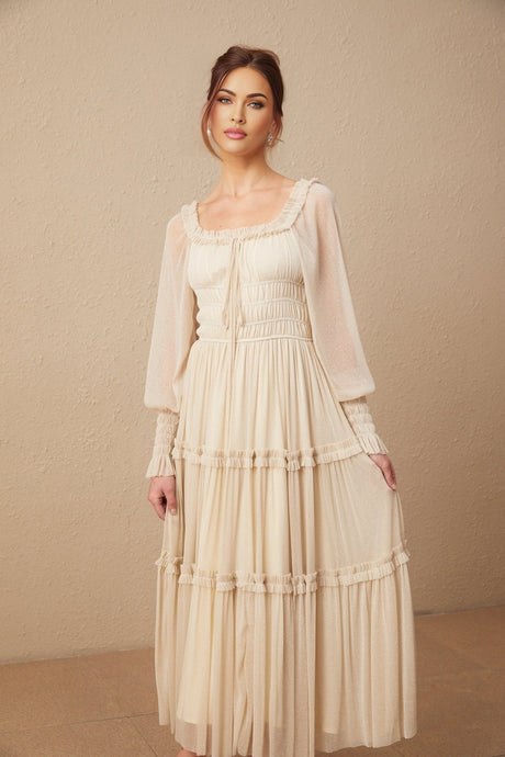 Woman wearing a pleated metallic midi dress with shirred detailing named Camille
