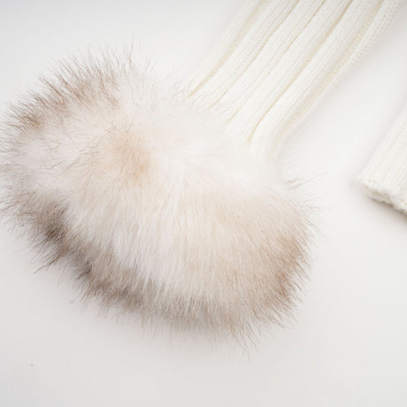 Woman wearing a plush faux fur jacket with ribbed knit details in light beige color