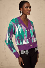 Woman wearing a purple knit top with argyle pattern design