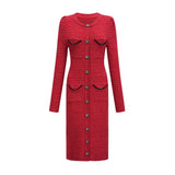 Woman wearing a red knit midi dress with embellishments standing in a neutral background