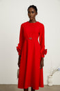 Woman wearing a red long sleeve dress with floral pattern
