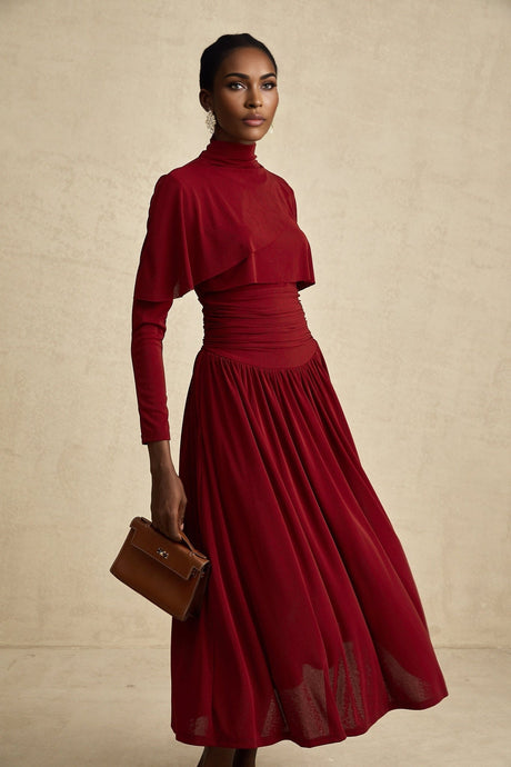 Woman wearing a red midi dress with ruched details and a flap design at the neckline