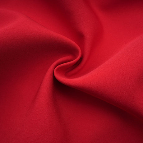Woman wearing a red mini dress with pleated skirt and embellished details