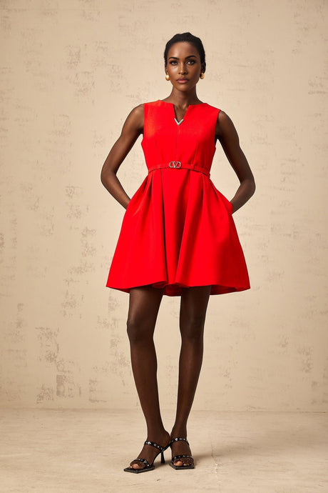 Woman wearing a red mini dress with split neckline and cinched waist