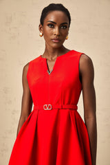 Woman wearing a red mini dress with split neckline and cinched waist
