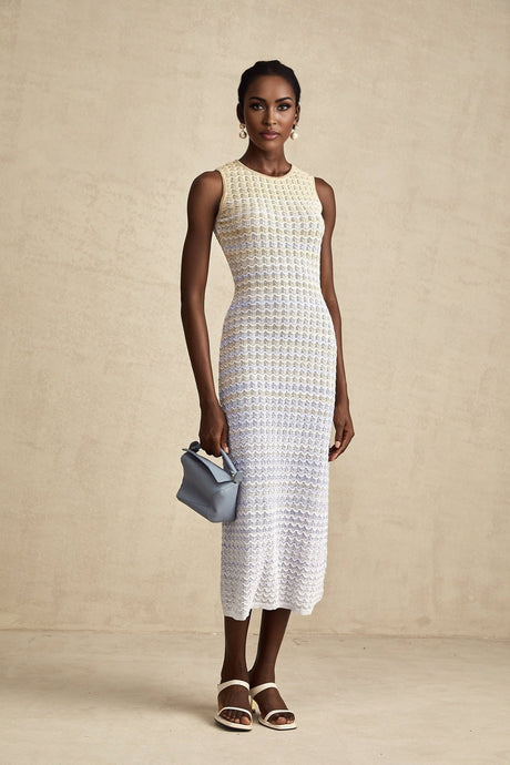 Woman wearing a ribbed knit midi dress with contrasting color details and a fitted silhouette