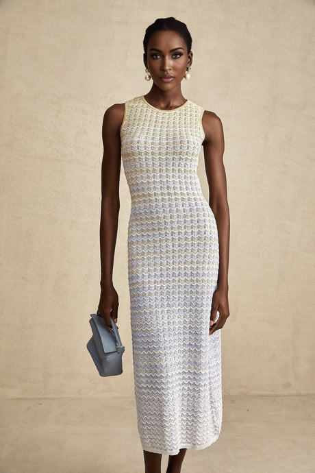 Woman wearing a ribbed knit midi dress with contrasting color details and a fitted silhouette