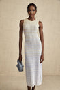 Woman wearing a ribbed knit midi dress with contrasting color details and a fitted silhouette