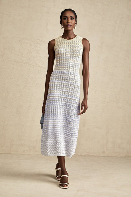 Woman wearing a ribbed knit midi dress with contrasting color details and a formfitting silhouette