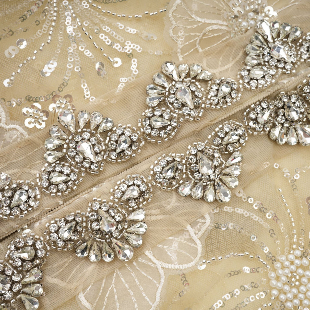 Woman wearing a semi sheer floral jacket with beaded details and organza fabric in a luxurious style