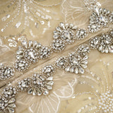 Woman wearing a semi sheer floral jacket with beaded details and organza fabric in a luxurious style