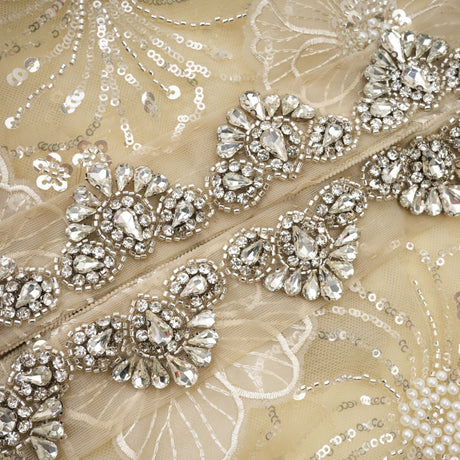 Woman wearing a semi sheer floral jacket with beaded details and organza fabric in a luxurious style