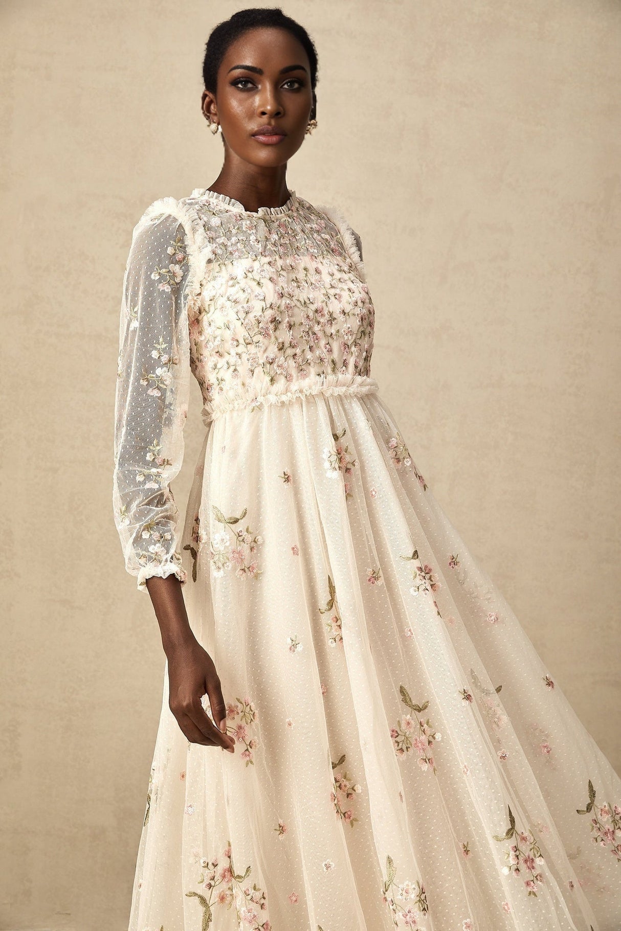 Woman wearing a sheer tulle midi dress with delicate floral embroidery in Celine style