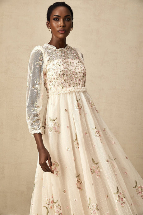 Woman wearing a sheer tulle midi dress with delicate floral embroidery in Celine style