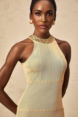 Woman wearing a shimmering long sleeve midi dress with ribbed texture and allover sequin detailing