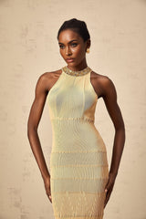 Woman wearing a shimmering silver midi dress with ribbed texture and sequin embellishments