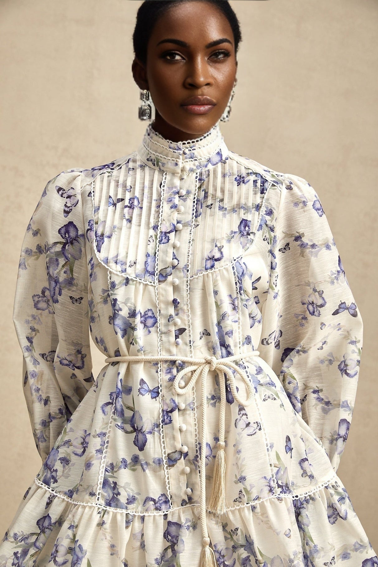 Woman wearing a short flared dress with floral print on light chiffon fabric