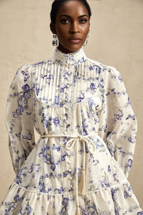 Woman wearing a short flared dress with floral print on light chiffon fabric