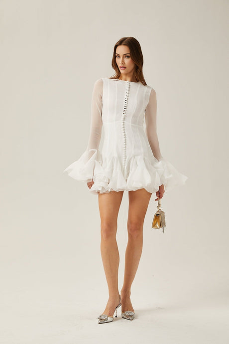 Woman wearing a short flared dress with semi sheer fabric in flowy silhouette