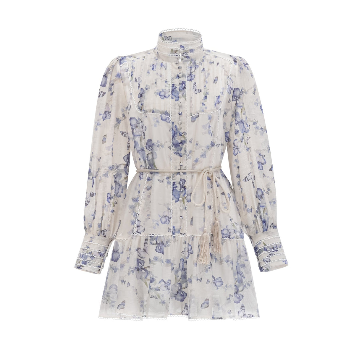 Woman wearing a short floral print dress with flared sleeves and a flowy chiffon fabric in light colors against a plain background