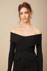 Woman wearing a short offshoulder dress with ribbed knit texture in a fitted silhouette