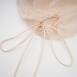 Woman wearing a short offshoulder dress with ruched detailing and selftie straps layered design in a mini length