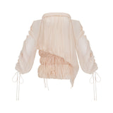 Woman wearing a short offshoulder dress with ruched details and selftie elements in a layered design