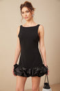 Woman wearing a short ruffled dress with an open back design