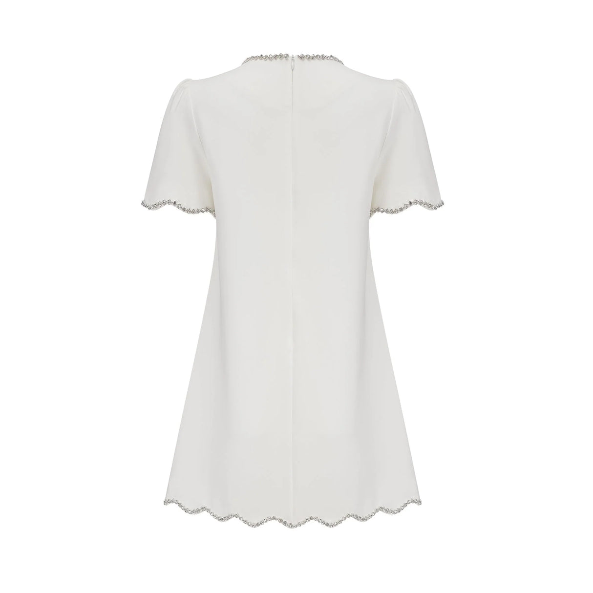 Woman wearing a short white dress with crystal embellishments