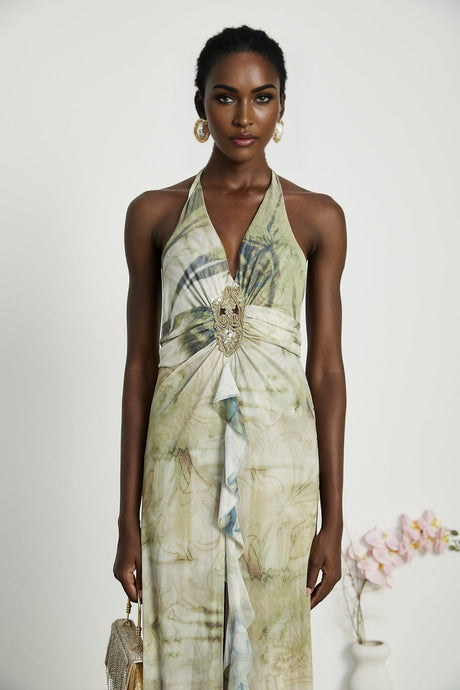 Woman wearing a sleeveless midi dress with a neckholder design featuring an ombre print pattern in blue tones