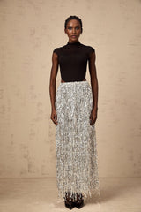 Woman wearing a twotone corset style top and matching skirt set in black and white colors