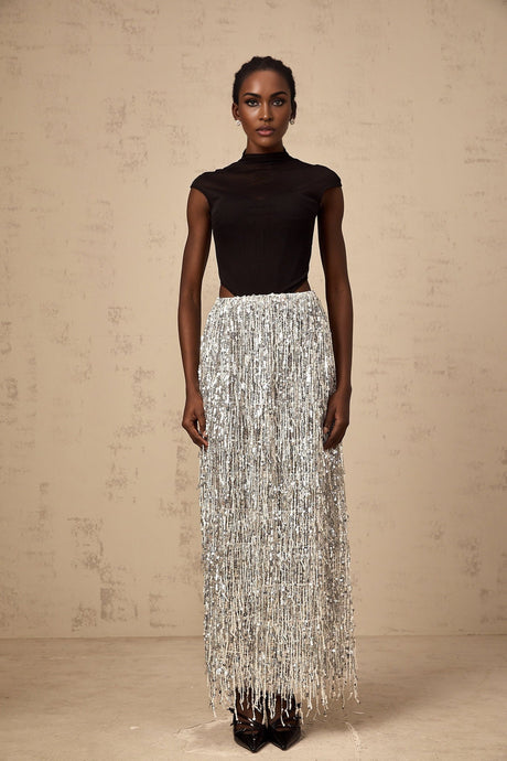 Woman wearing a twotone corset style top and matching skirt set in black and white colors