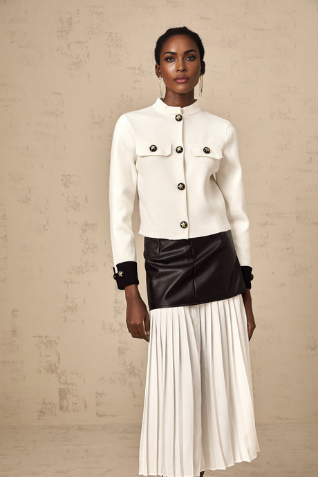 Woman wearing a white knitted jacket with contrasting color details