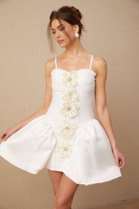 Woman wearing a white mini dress with floral pattern and bustier style top