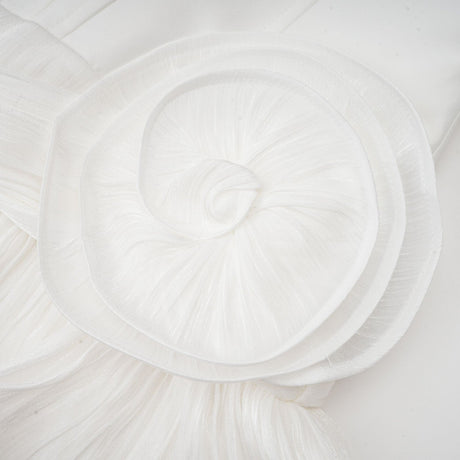 Woman wearing a white mini dress with full pleats and cinched waist detail