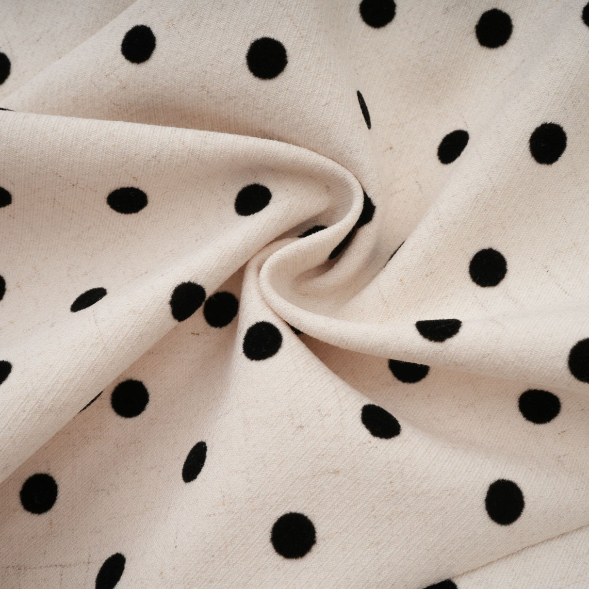 Woman wearing beige polka dot mini dress with puff sleeves and gathered skirt