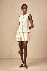 Woman wearing beige sequined knit vest top and matching skirt set