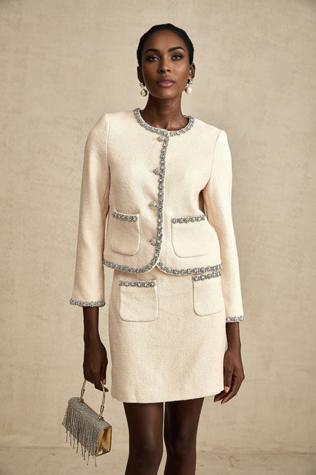 Woman wearing beige tweed cardigan and matching skirt set with crystal embellishments named Elisabeth