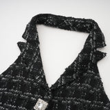 Woman wearing black and white checked tweed vest top and matching skirt set called Axelle