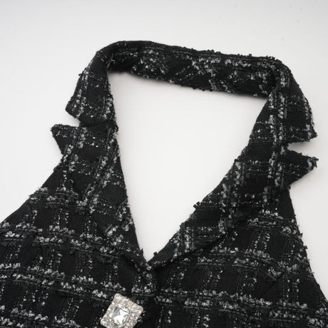 Woman wearing black and white checked tweed vest top and matching skirt set called Axelle
