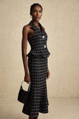 Woman wearing black and white checked tweed vest top and matching skirt set named Axelle