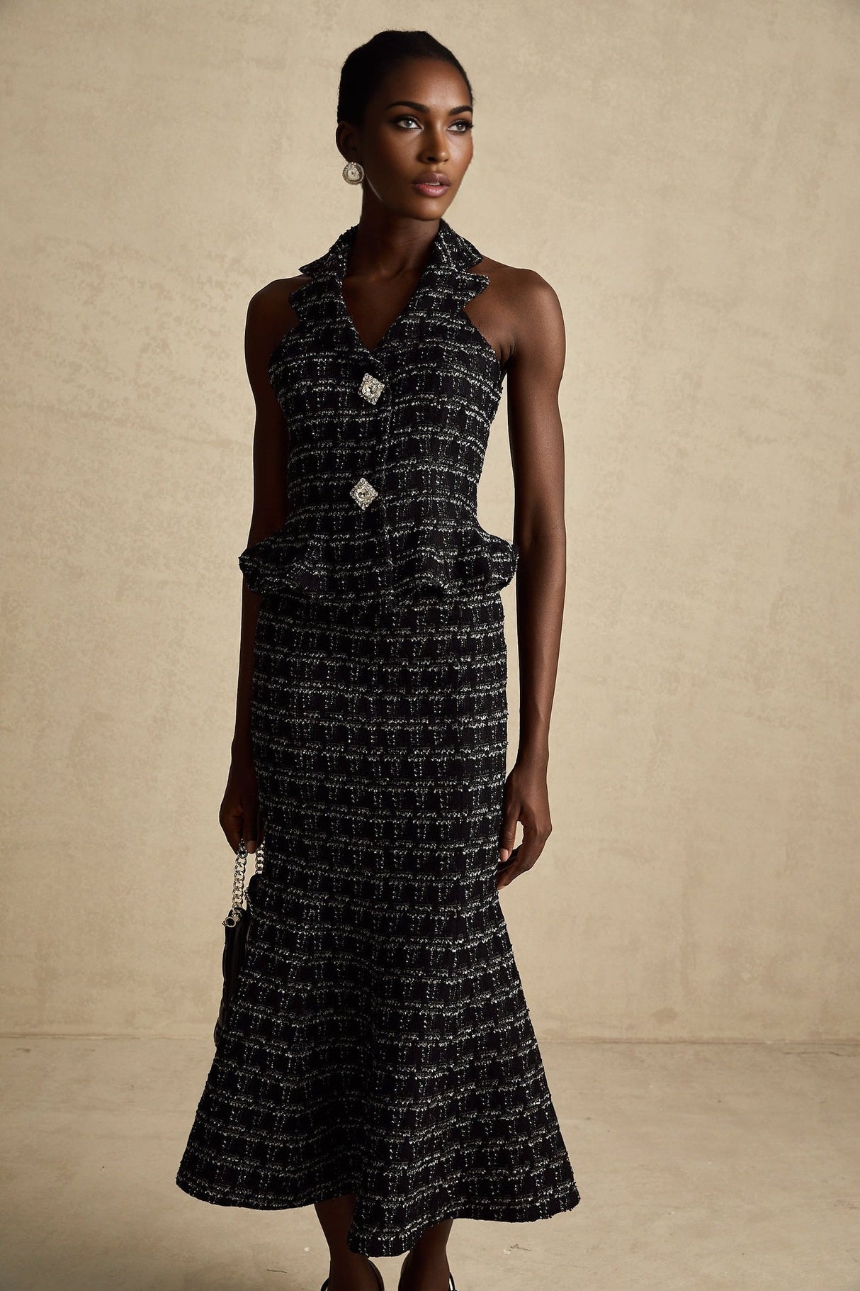 Woman wearing black and white checked tweed vest top and matching skirt set named Axelle