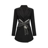 Woman wearing black blazer with bowknot detail and cutout design