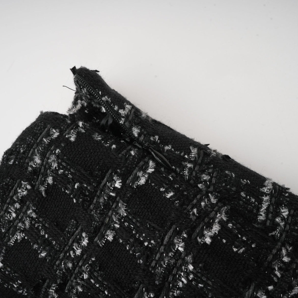 Woman wearing black checked tweed vest top and matching skirt set called Axelle