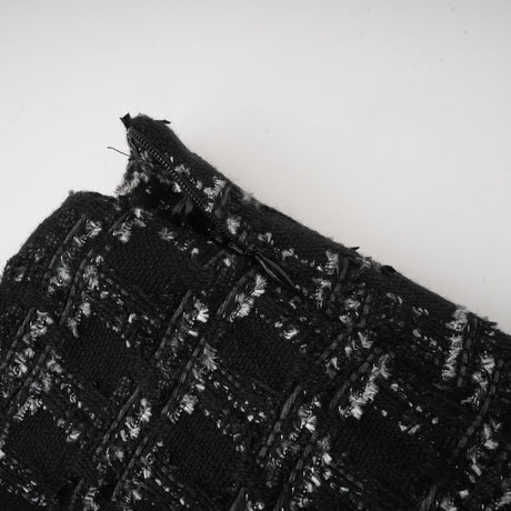 Woman wearing black checked tweed vest top and matching skirt set called Axelle