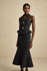 Woman wearing black checked tweed vest top and matching skirt set named Axelle