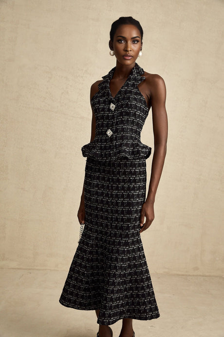 Woman wearing black checked tweed vest top and matching skirt set named Axelle