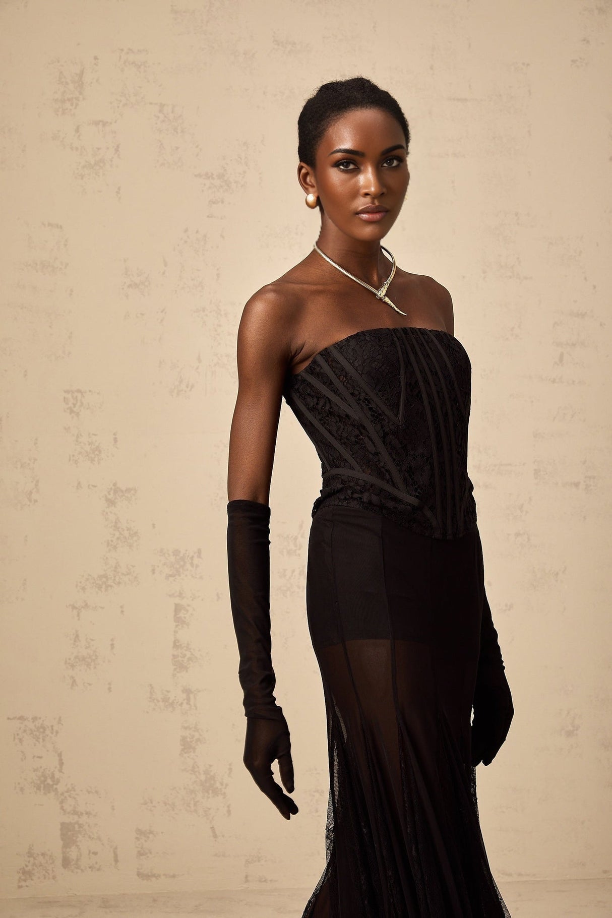 Woman wearing black floral lace corset skirt and gloves matching set Violaine style