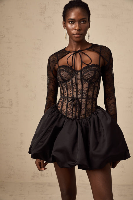 Woman wearing black floral lace sleeveless vest and matching dress set