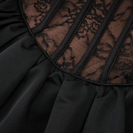 Woman wearing black floral lace sleeveless vest over matching dress with floral lace pattern